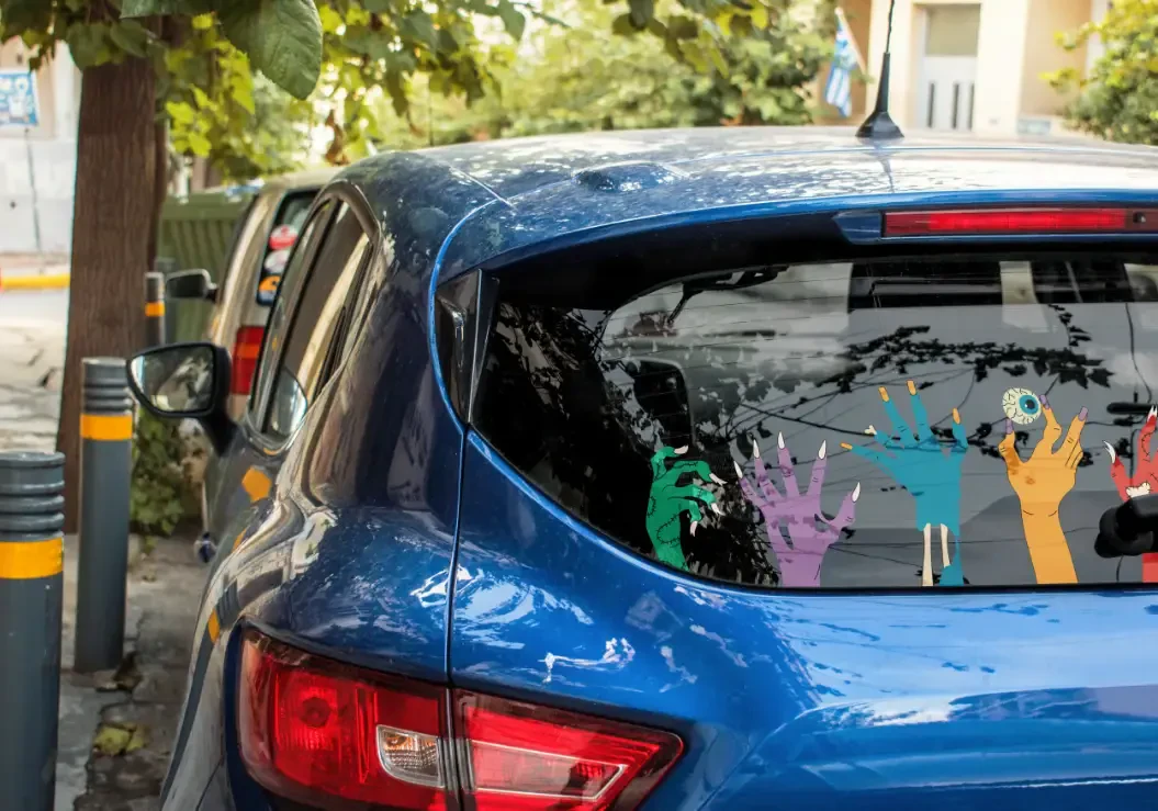 Zombie hand stickers on the back window of a car
