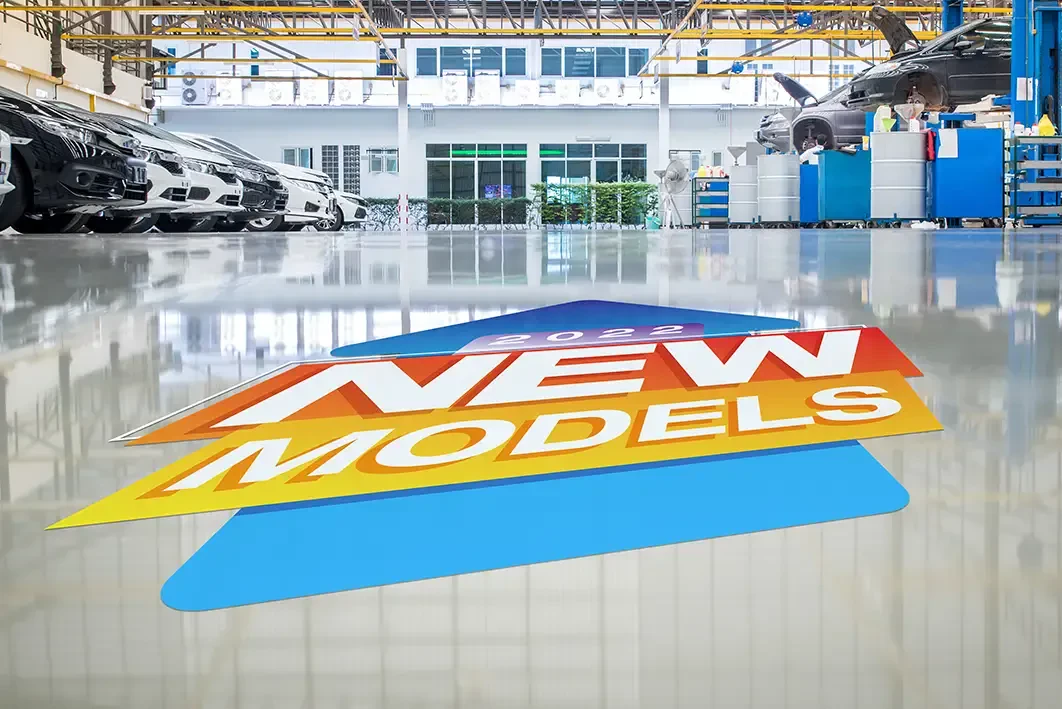 A floor graphic on the floor of a car dealership