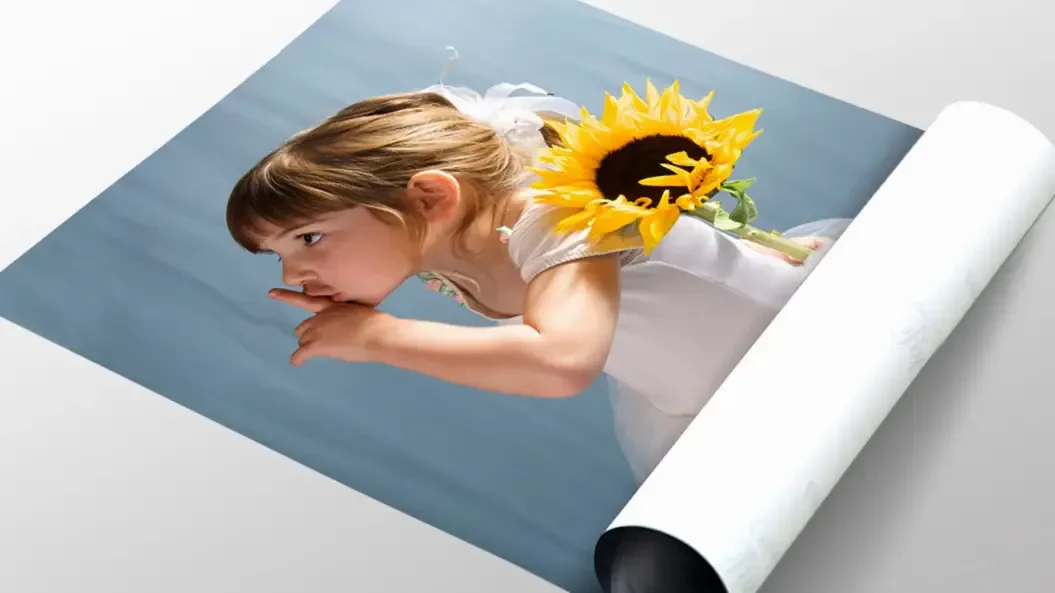 A printed photo of a little girl with a sunflower