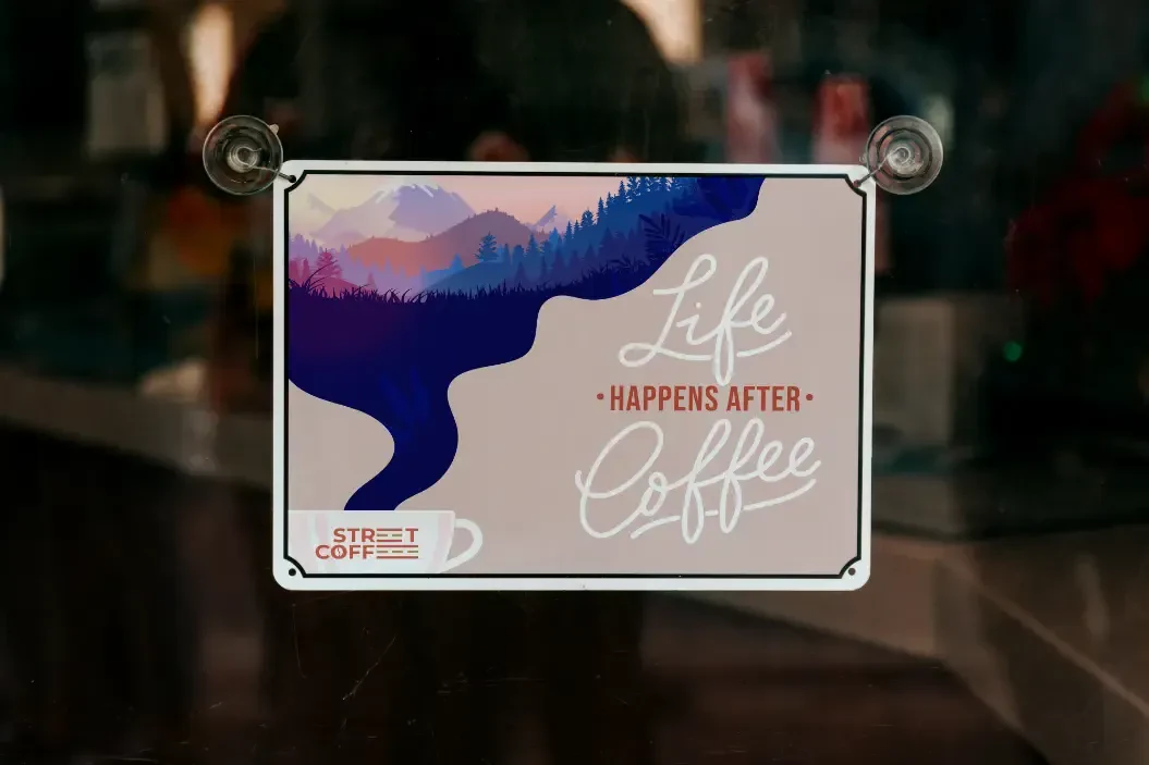 Printed sign hangin in a coffee shop window
