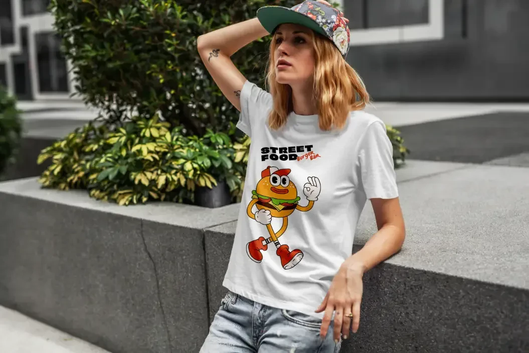 A woman wearing a tee shirt with an illustrated burger printed on it