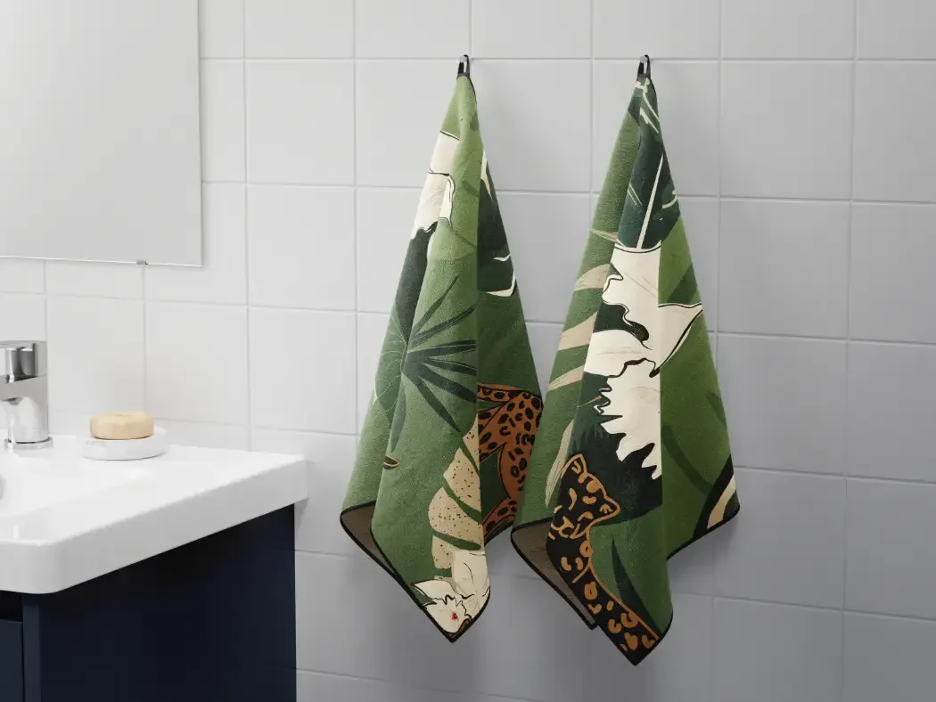 Printed hand towels hanging in a bathroom