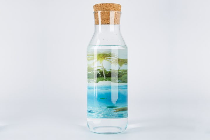 glass bottle with cork that displays a graphic printed inside the bottle