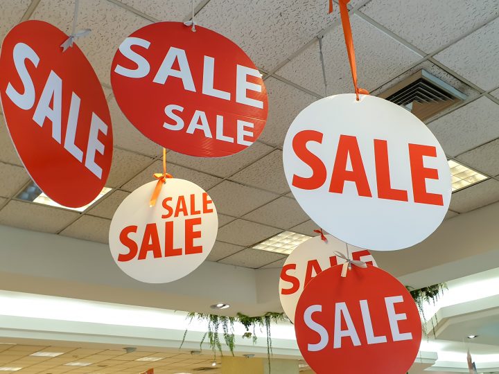 sale signs hanging from ceiling