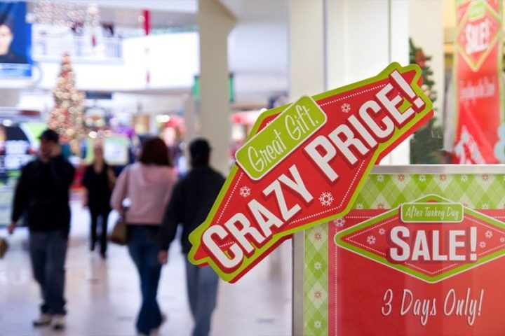 printed advertisement for holiday gift prices displayed in mall