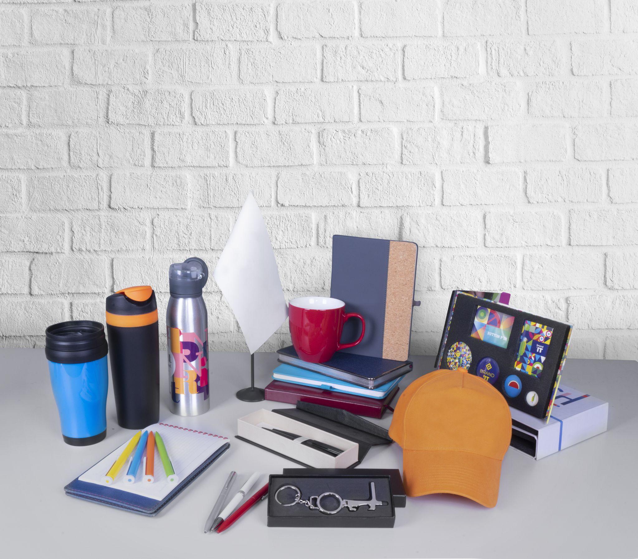 Composition of different promo products - Thermo mug, mug, gifts, pens in boxes, notebooks, tools, cap,flag table.