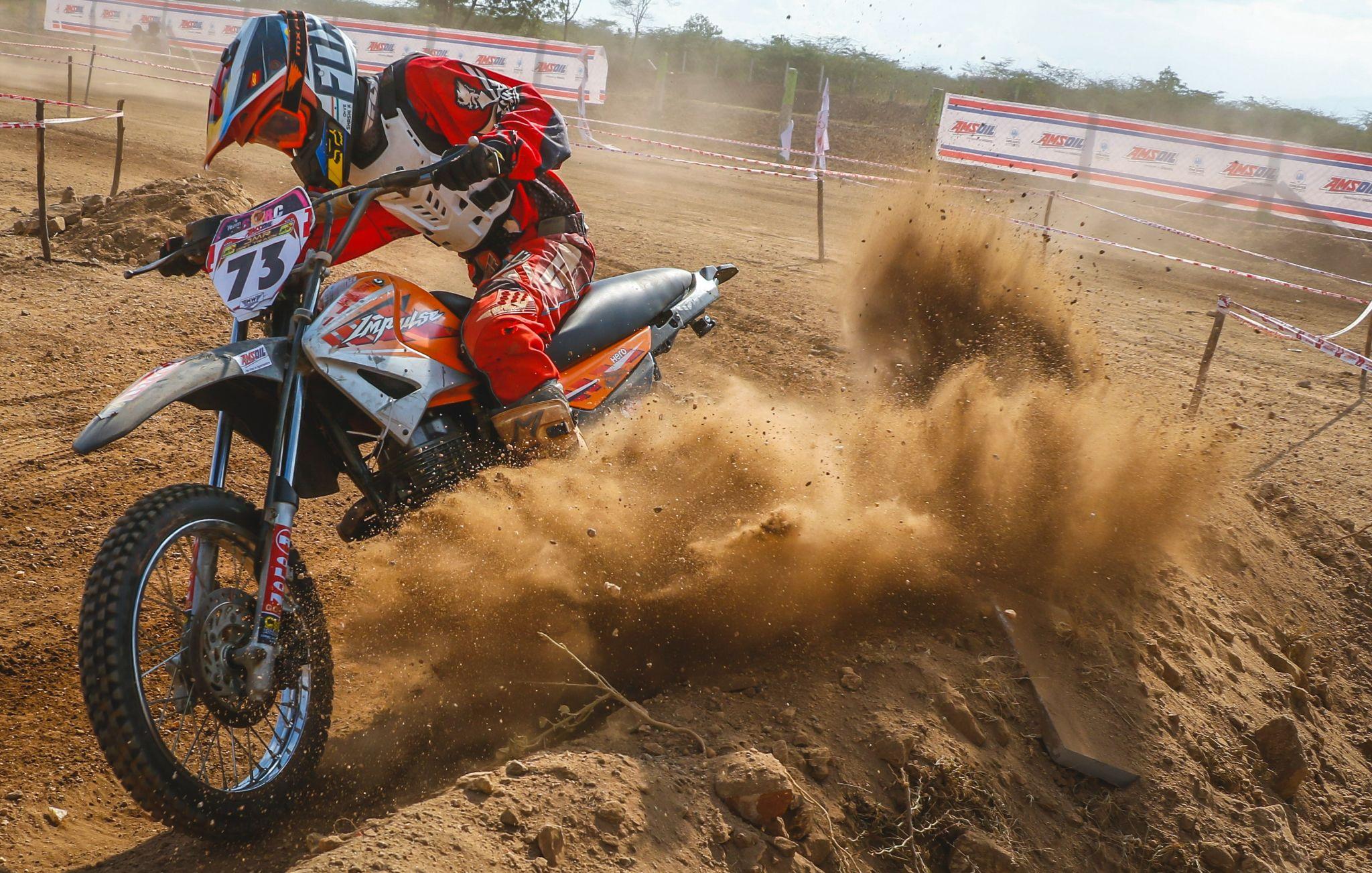 Racer on a motorcycle close-up on a dirt track.